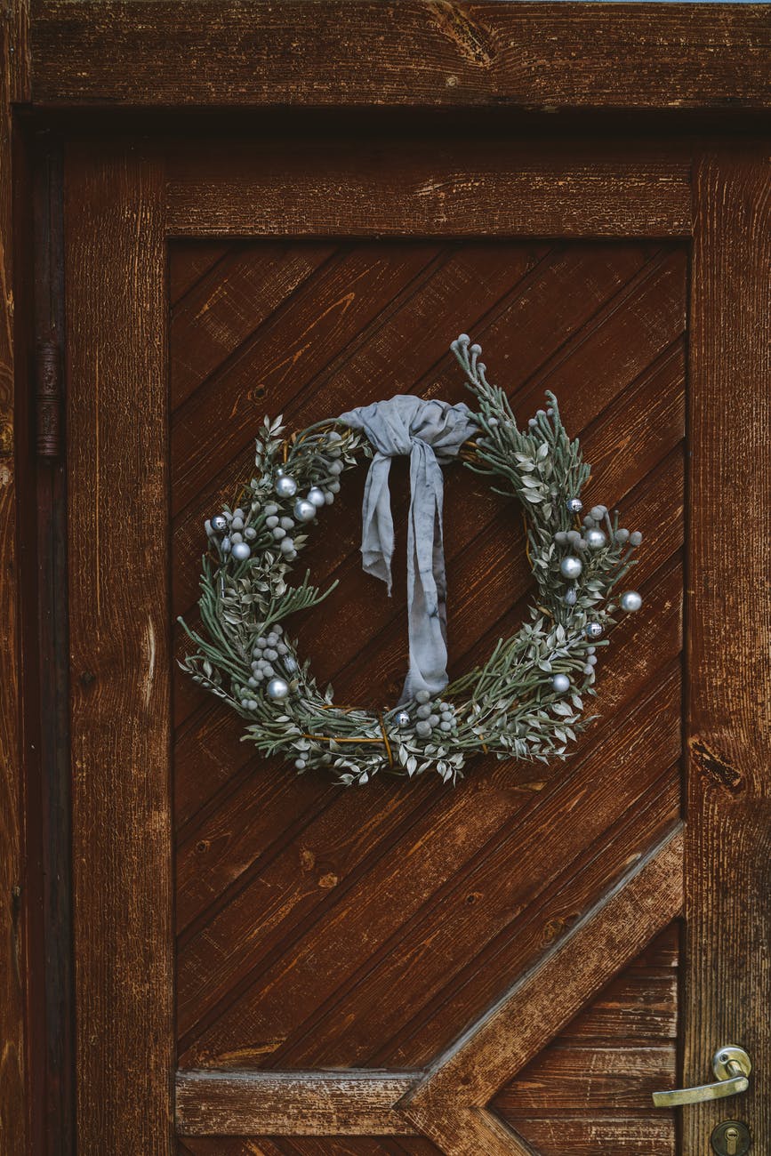 a christmas wreath hanging on the door